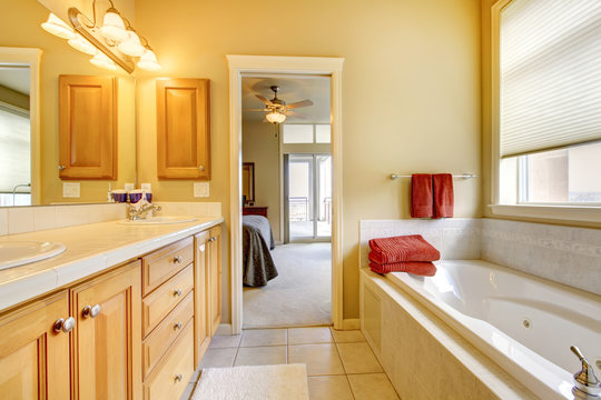 Bathroom with wood cabinets and tub.