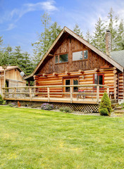 Rustic log small cabin deck exterior.