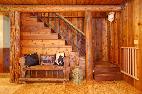 Rustic log cabin stairace and bench details.