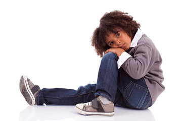 Portrait of an african american little boy sitting on the floor