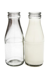 full and empty milk bottles with clipping path