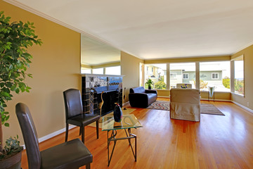 Large living room with black fireplace and hardwood floor.