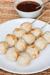 Close-up of roasted pork ball with sauce