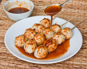 Roasted pork ball, pouring with sweet spicy sauce