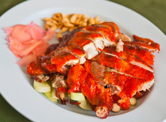 Preparing roasted duck with garnish