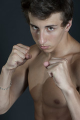 Fototapeta na wymiar Young guy in a boxing stance