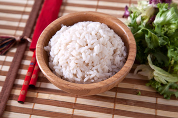 Rice in bamboo bowl with chopsticks