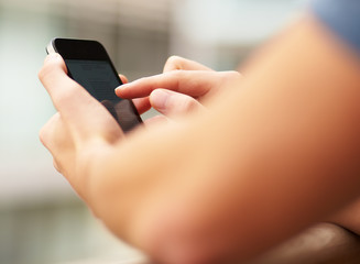 Young man touching a modern mobile, closeup
