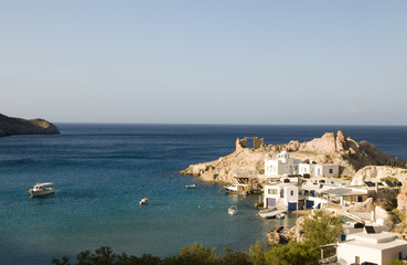 houses built into rock cliffs on Mediterranean Sea Firopotamos M
