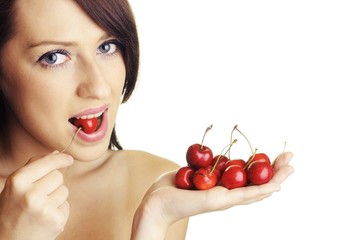 Beautiful brunette with cherry fruit on white background