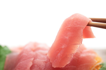 Sashimi, sliced raw tuna with chopsticks