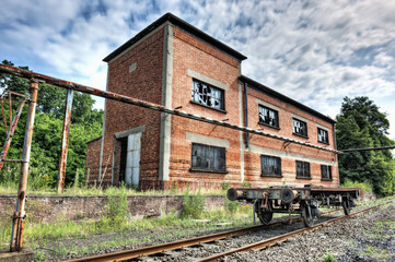 Fototapeta na wymiar Porzucone wagon przed starym budynku przemysłowym