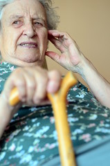 senior woman holding wooden cane