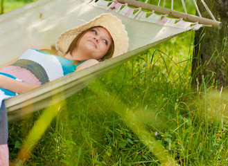 beautiful woman outdoors in summer on hammock