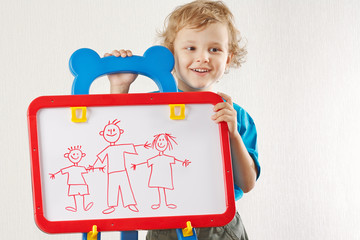 Little smiling cute boy shows his family painted on a whiteboard