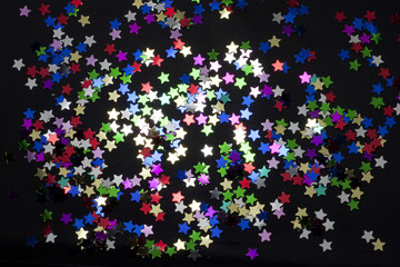 confetti stars shining abstract background in dark