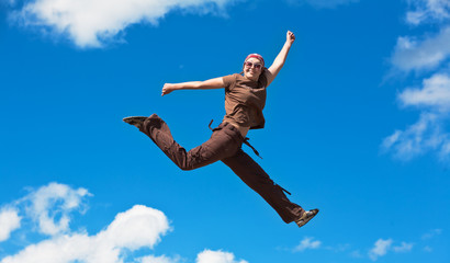 jumping girl with hands up against
