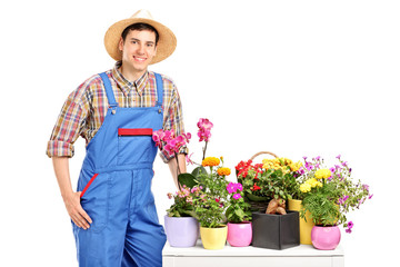 A male florist posing next to flowers