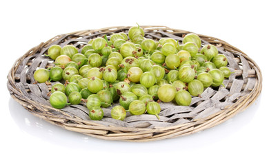 Green gooseberry on wicker mat isolated on white