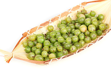 Green gooseberry in basket isolated on white