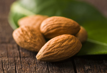 Migdały z liściem na drewnianym tle