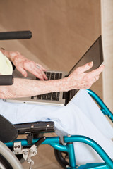 Woman on Wheelchair Using Laptop