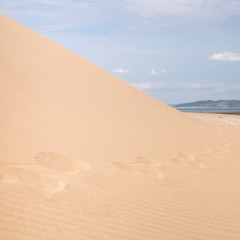 Sand dune with footsteps