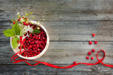 wild strawberries on wooden background
