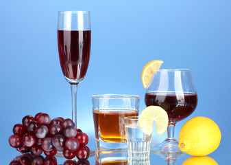 a variety of alcoholic drinks on blue background