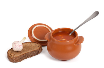 Borsch in clay pot with bread and garlic