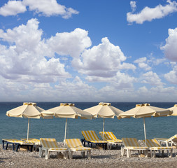Fototapeta na wymiar sun umbrella and chairs on a beach