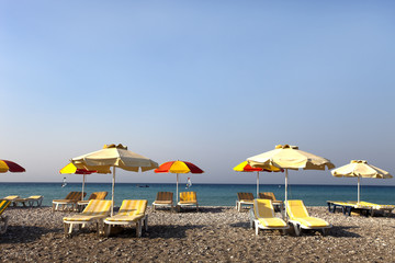 sun umbrella and chairs on a beach