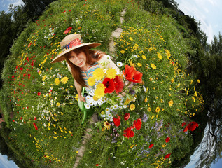 smiling woman with a bunch of flowers in her garden