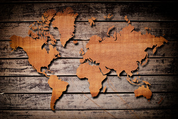 World map carving on wood plank.