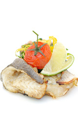 healthy meal with fish meat, a lime of lime and a tomato