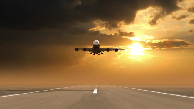airplane landing against sunset background