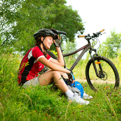 Happy Young Woman riding bicycle outside. Healthy Lifestyle