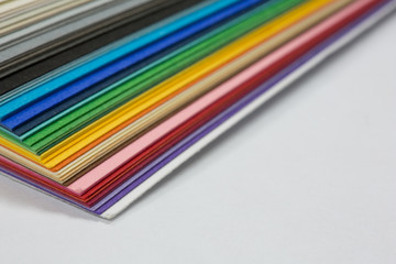 edge of the stack of colored paper