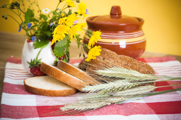 Still life with bread, flowers and pot