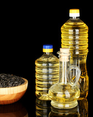 sunflower oil in bottles on black background close-up