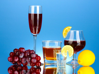 a variety of alcoholic drinks on blue background