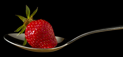 red,fresh strawberry on spoon