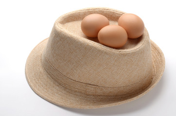 Fototapeta na wymiar eggs on beige fabric hat