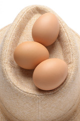 close up of eggs on beige fabric hat