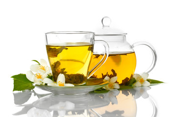 green tea with jasmine in cup and teapot isolated on white