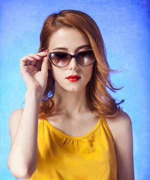 American redhead girl in sunglasses. Photo in 60s style.
