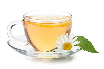 Cup of tea with lemon slice, mint leaves and chamomile flower