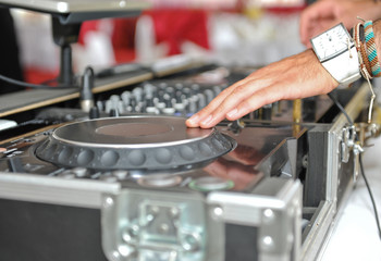 Working Disc jockey at party. Detail of a dj hands.