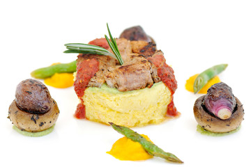 meal with meat polenta vegetable and sipcy sauce