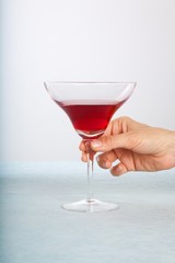 holding red cocktail